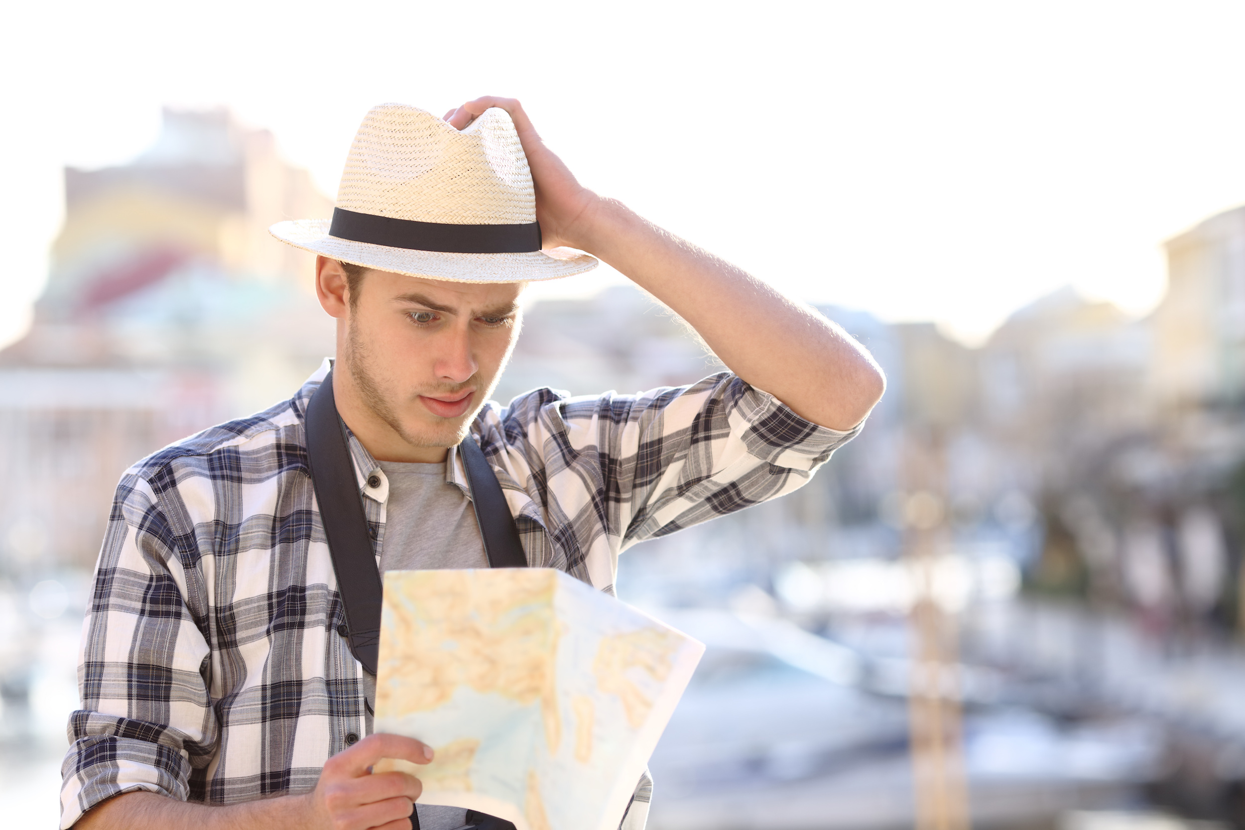 Lost tourist consulting guide in a coast town